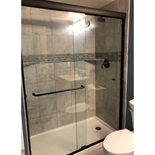 Bypass sliding door with dark hardware and gray tile