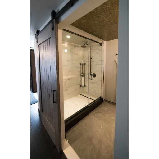 Heavy glass frameless pivot door with dark tile