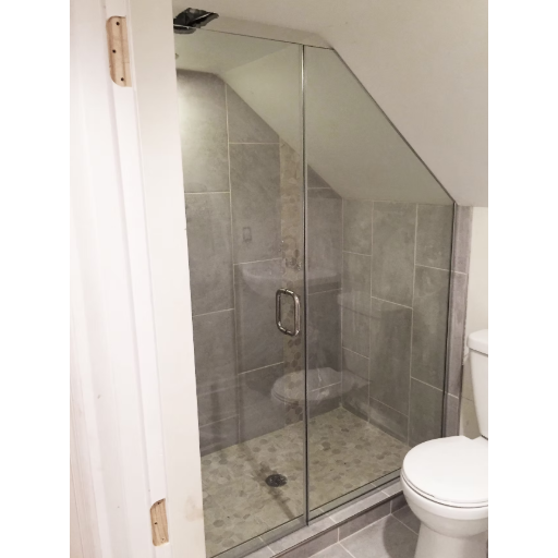 Custom heavy glass swing door under sloped ceiling