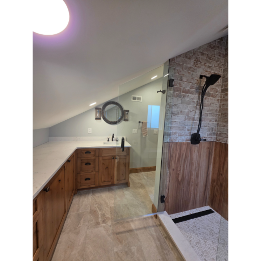 Custom heavy glass enclosure with stone wall and wood vanity
