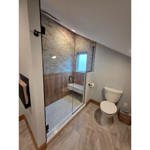 Custom heavy glass tub enclosure under sloped ceiling