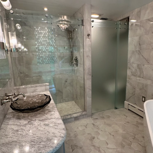 Frameless enclosure with frosted glass panel and marble floor